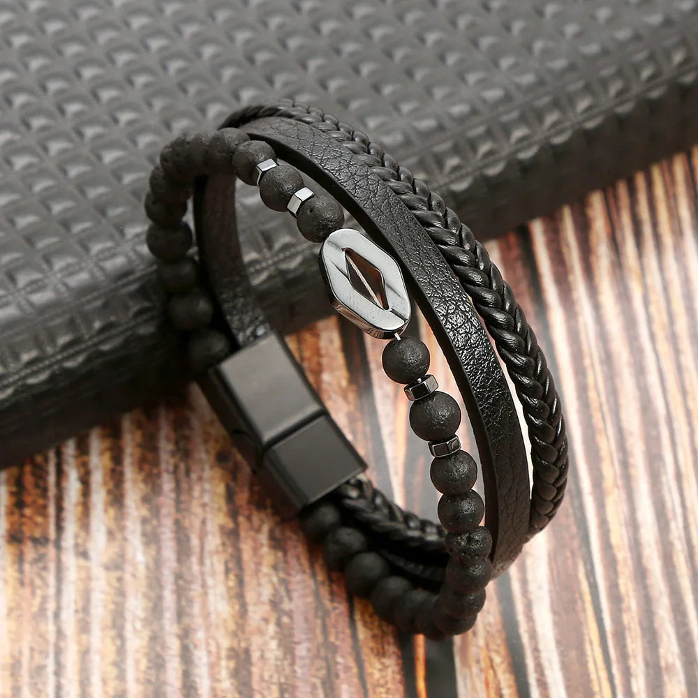 A black leather bracelet featuring a braided design and tiger eye beads resting on a wooden surface.