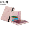 A pink premium PU leather travel passport holder with slots for documents and a charm design.