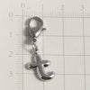 Silver stainless steel alphabet letter charm with a lobster clasp placed on a ruler for scale.