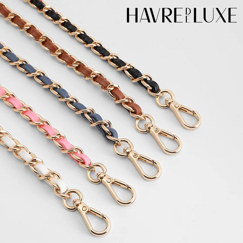 Several gold and black leather straps with buckles are displayed against a white background.