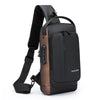 A black anti-theft zippered crossbody bag with a brown accent and adjustable strap.
