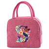 A pink insulated canvas lunch bag featuring a floral butterfly design.