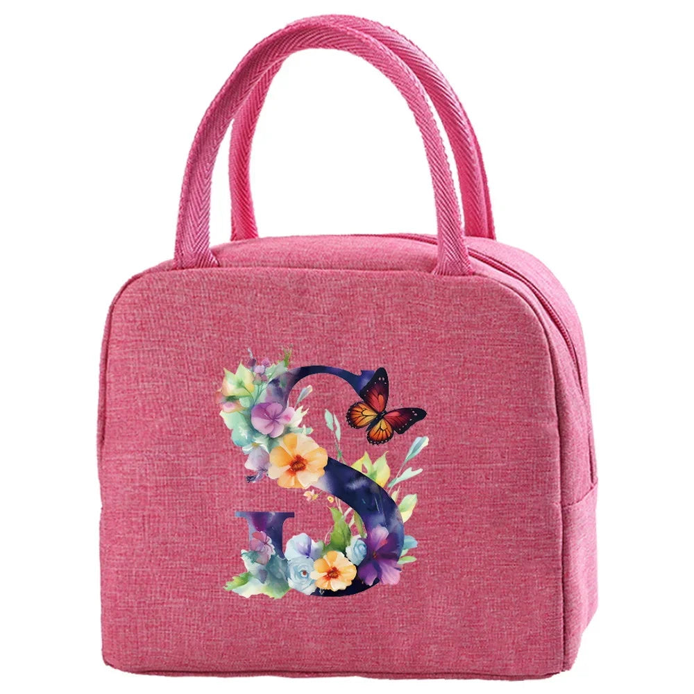 A pink insulated canvas lunch bag featuring a floral butterfly design.