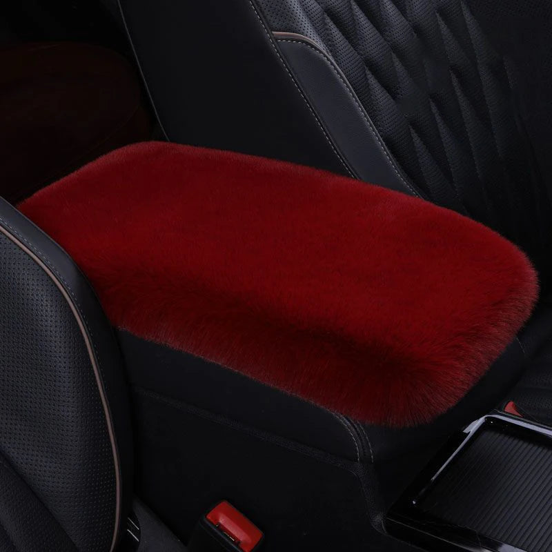 A deep red plush car armrest cushion set is shown inside a black car interior.