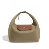 A beige nylon dumpling crossbody shoulder bag with a brown strap and a leather accent patch.