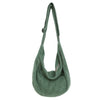 A green corduroy casual crossbody shoulder bag hanging vertically.