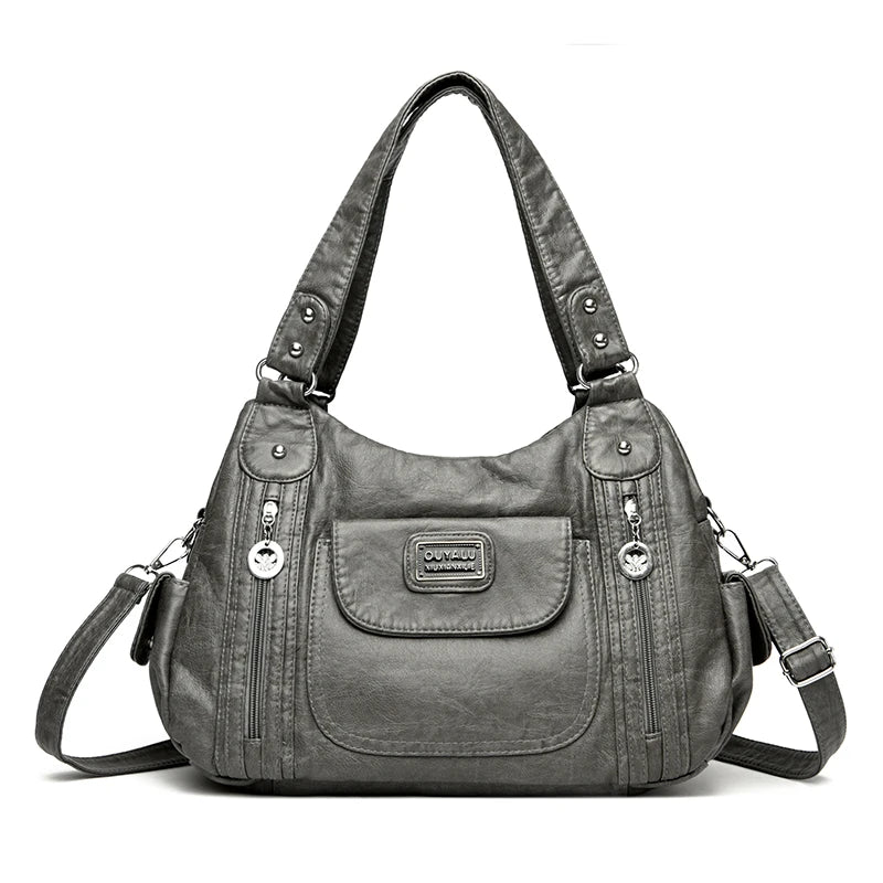 Dunkelgrabe Vintage-Ledertasche aus weichem PU-Leder mit Klappe und Reißverschlusstaschen.