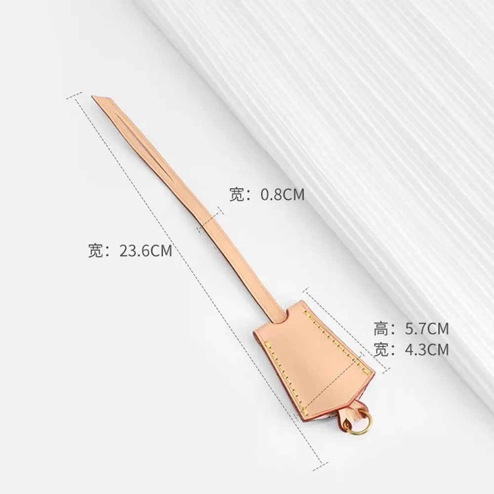A rose gold leather shoulder strap with measurements shown, used for bags.
