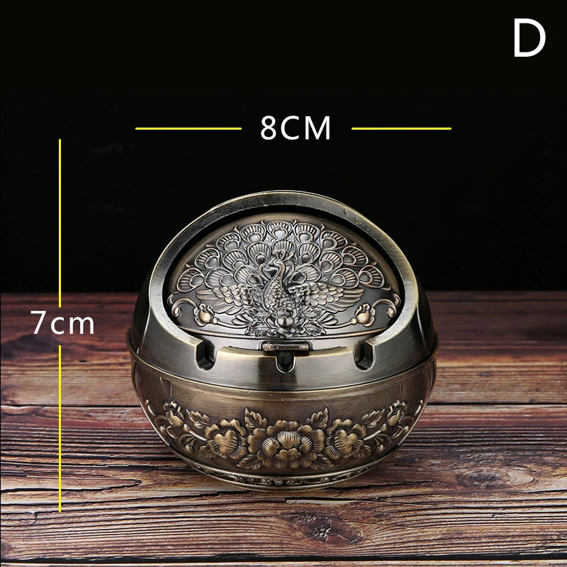 Vintage metal ashtray with a rose embossing design shown on a wooden surface.