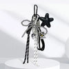 A collection of black and silver beaded keychains featuring a star charm and various charms for bags and backpacks.