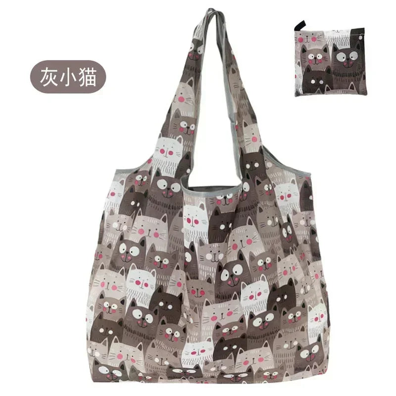 A patterned tote bag featuring cute cat designs in shades of gray and brown.