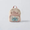 A light pink fuzzy backpack featuring a blue Stitch character design.