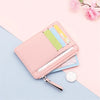 A pink PU leather card holder wallet with a zipper and keychain is shown against a light blue background.