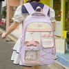 A woman wearing a light purple Candy Color Campus backpack with pink accents and a white dress, standing outside a storefront