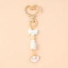 Gold starfish keychain with pearl accents and a heart charm