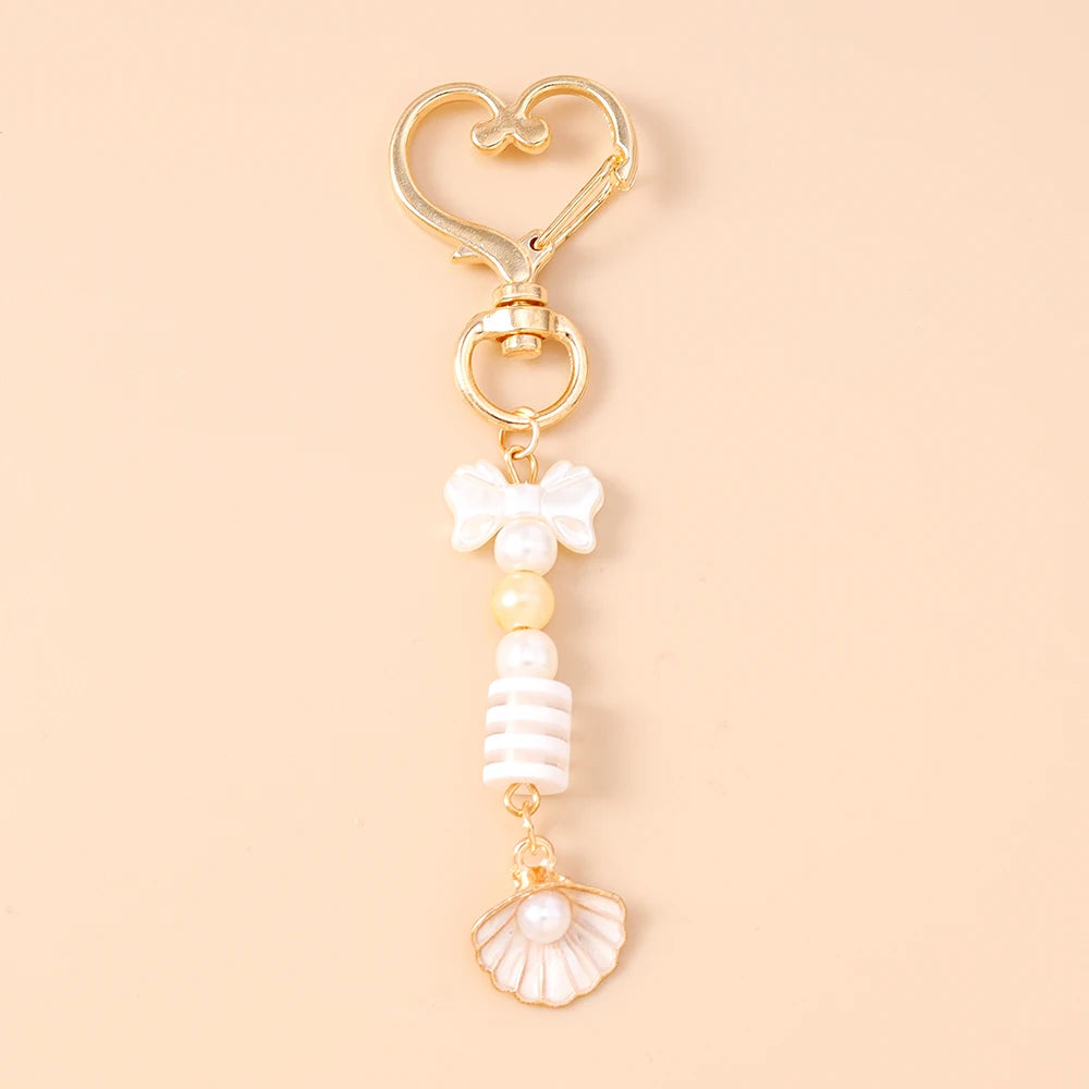 Gold starfish keychain with pearl accents and a heart charm