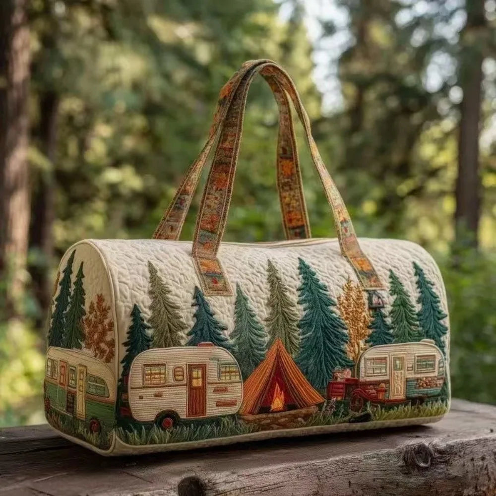 A quilted travel duffel bag featuring a forest scene with camping vehicles and trees.