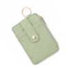 A light sage green PU leather card holder wallet with a quilted pattern and a gold-toned ring.