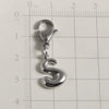 Silver stainless steel alphabet letter charm shaped like the letter S with a lobster clasp, measured against a ruler.