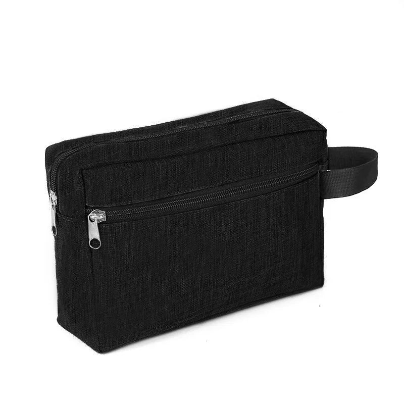 Black travel cosmetic bag with a zippered compartment and a strap.