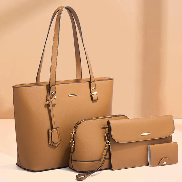 A set of four tan leather bags including a large tote and smaller pouches displayed on a light surface.