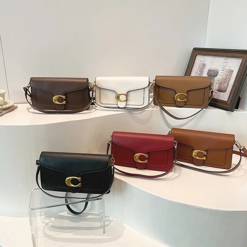 A display of women's premium textured shoulder bags in brown, cream, and burgundy leather.