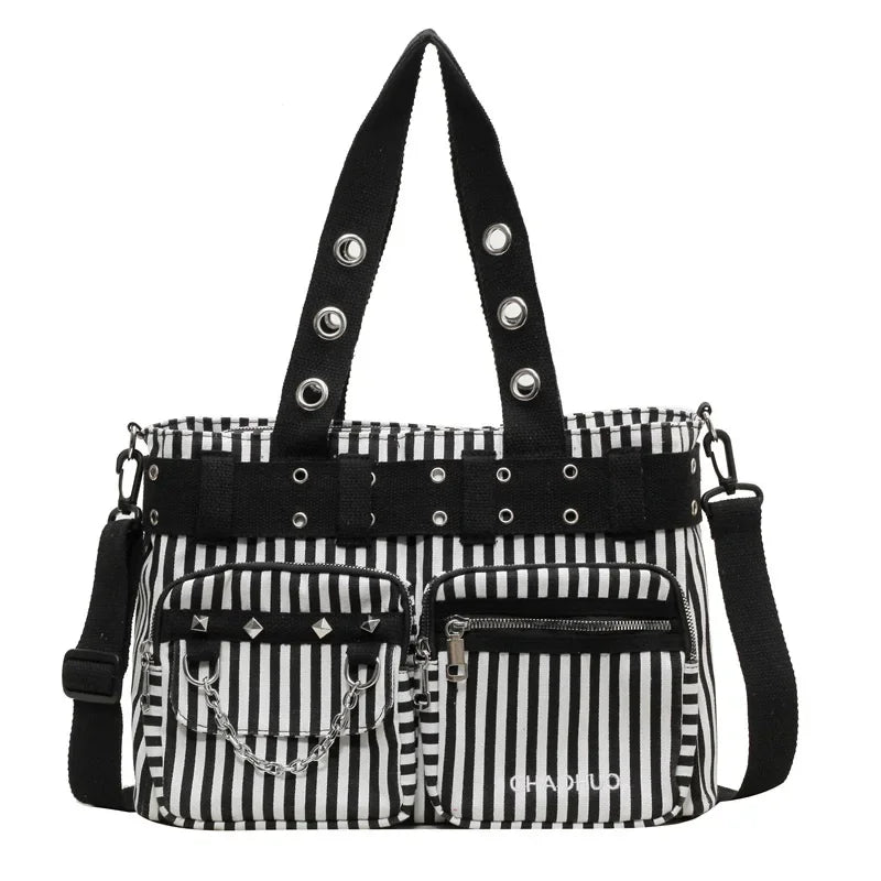 Black and white striped nylon shoulder bag with studded straps and pockets