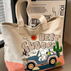 A beige canvas shoulder bag featuring a Snoopy cartoon design of a blue jeep and a cactus.