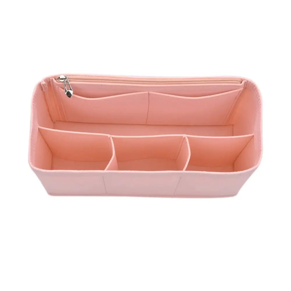 A pink felt insert liner designed to organize and protect items inside a handbag.