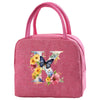 A pink insulated canvas lunch bag with a butterfly and floral design.