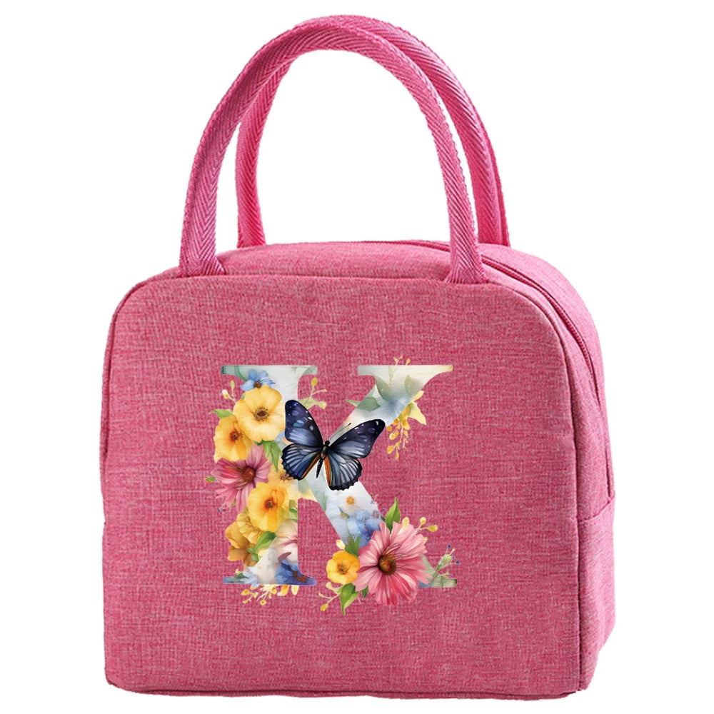 A pink insulated canvas lunch bag with a butterfly and floral design.