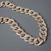 A flexible chain strap made of light beige and white marbled acrylic resin.