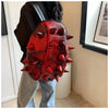 A red, hedgehog-shaped PU leather backpack worn by a person.