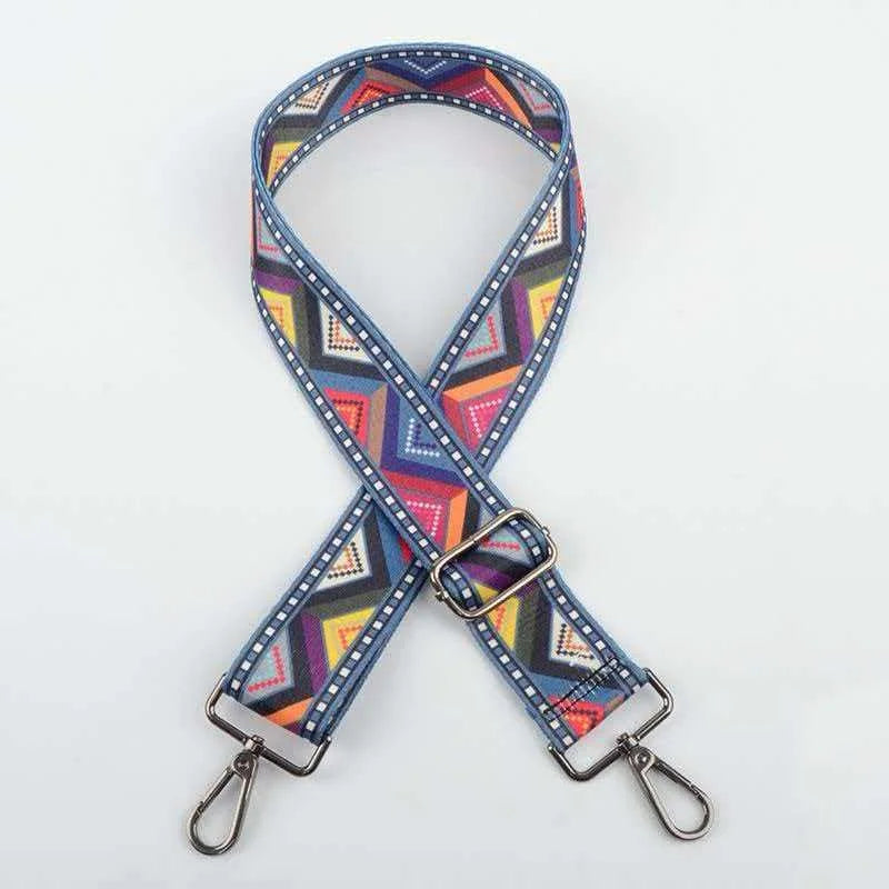 A blue and purple patterned adjustable crossbody strap for a handbag.
