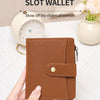A brown multi-card slot wallet is held in a hand, displayed next to a clock and flowers.