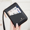 A hand holds a black RFID-blocking passport wallet with a zipper closure displaying a Korean passport.