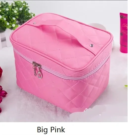 A pink quilted cosmetic storage box with a zipper is shown on a white surface.