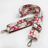 A beige and pink jacquard patterned strap for an adjustable wide crossbody bag.