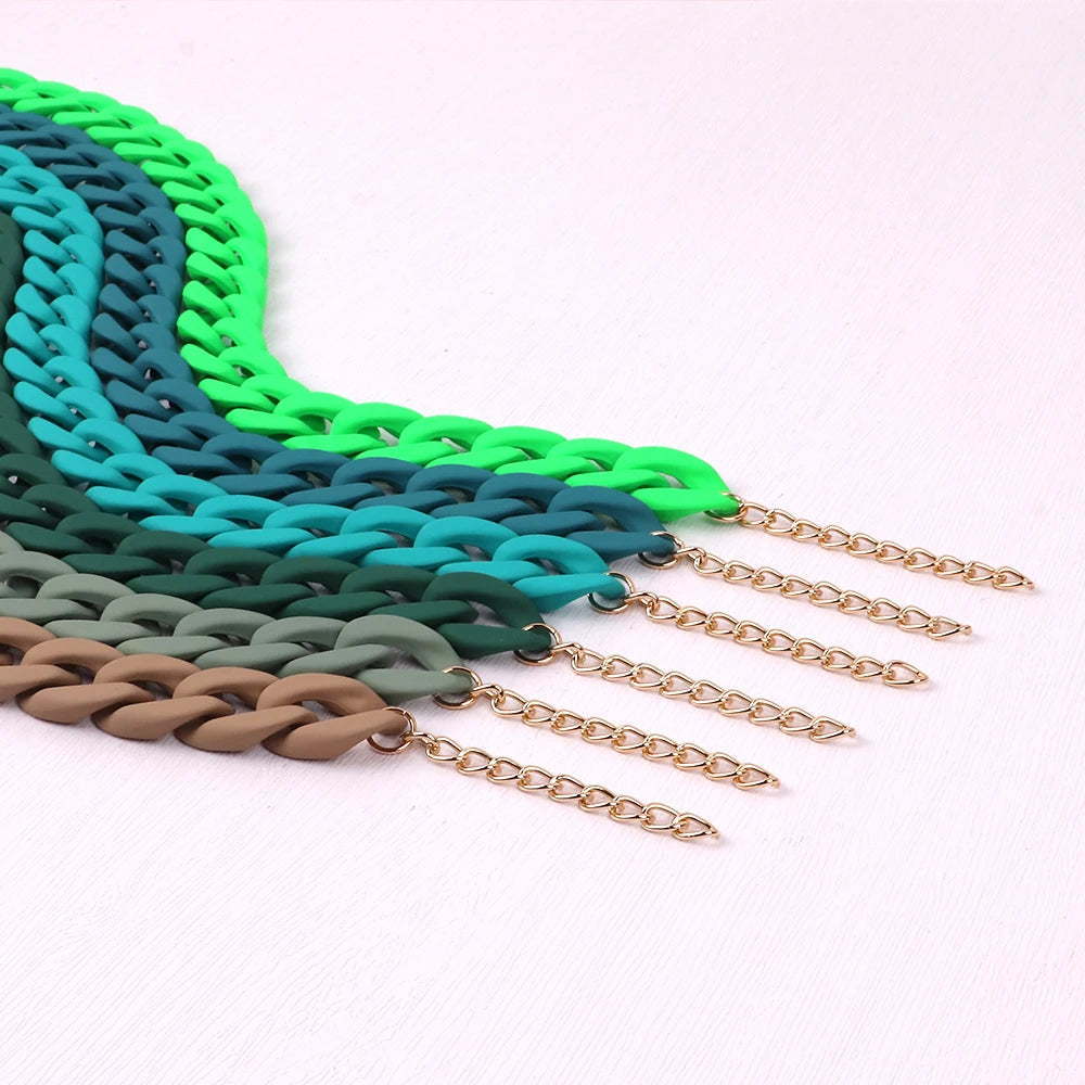 A gradient acrylic statement choker necklace featuring multiple shades of green and teal.
