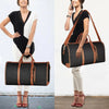 A woman is shown holding a black foldable multi-function garment duffle bag with brown leather accents.