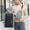 A young man wearing a beige sweater carries a gray backpack and a matching wallet.