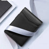 A black and silver minimalist slim wallet is shown against a white background.