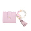 A pink silicone bead bracelet with a leather card holder and tassel charm.