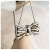 Silver elegant bowknot evening bag with a detachable chain strap displayed against a light background.