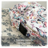 A side view of a white backpack featuring a colorful butterfly pattern on the fabric.