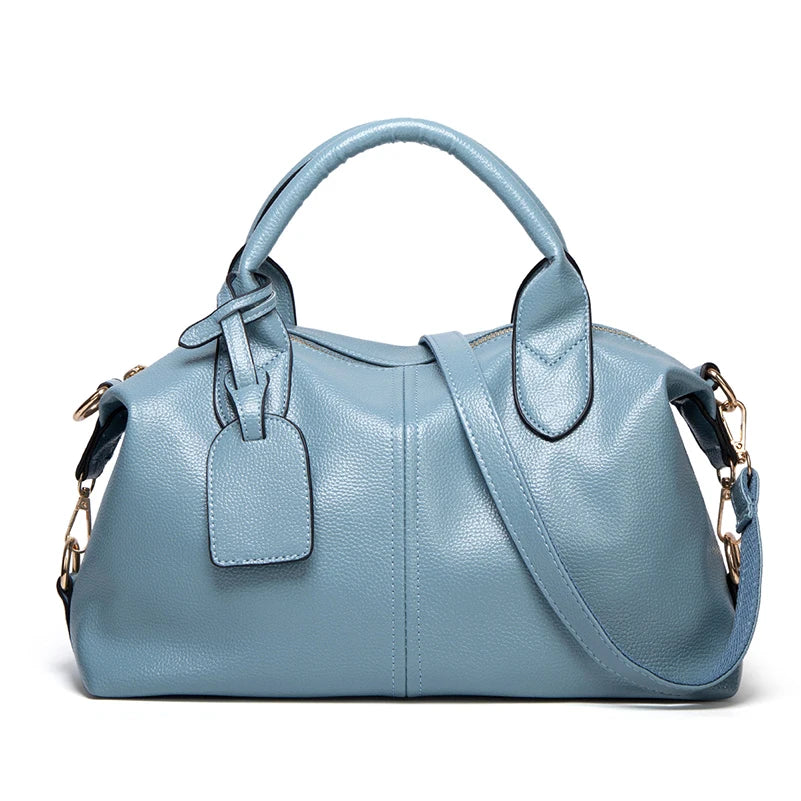 A light blue faux leather Boston handbag with a handle and flap closure.