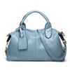 A light blue faux leather Boston handbag with a handle and flap closure.