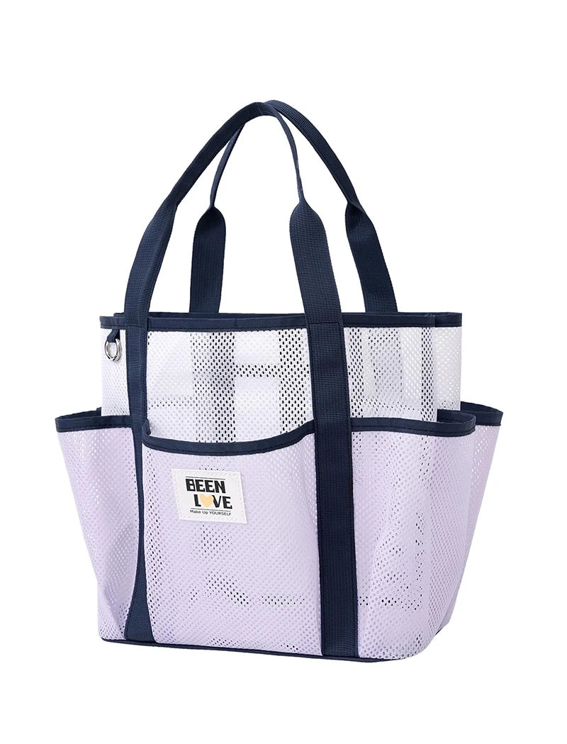 A light purple mesh beach tote bag with dark blue handles and trim.