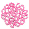 A pile of pink acrylic link chain connectors with small clear rhinestones.