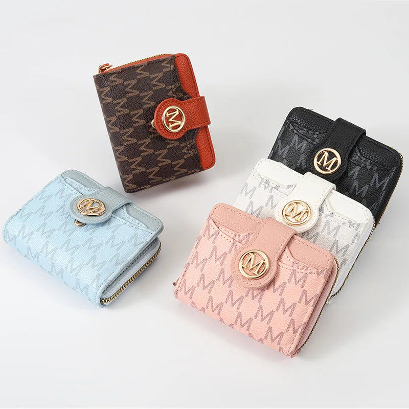 A collection of three compact wallets featuring different patterns and colors including brown plaid, black, and light blue.